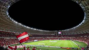 Green and White Soccer Field at Night Time